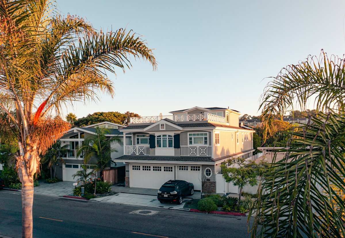 A white Southern California house with a green lawn